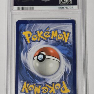 May include: A graded Pok&eacute;mon trading card encased in a clear plastic holder. The card features the Pok&eacute;mon logo and a Pok&eacute; Ball design on a blue background. The holder has a PSA label with a serial number.