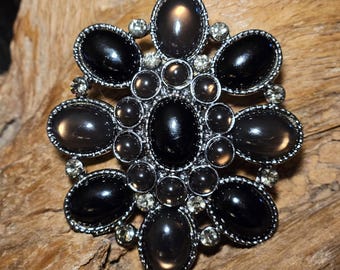 Broche precioso con piedras marrones y negras brillantes