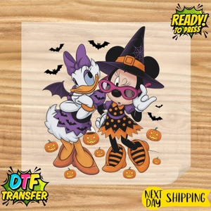 May include: A DTF transfer sheet featuring a cartoon illustration of Daisy Duck and Minnie Mouse dressed for Halloween. Daisy wears a purple bat-patterned dress and wings, while Minnie wears a witch hat, glasses, and a polka-dot dress among pumpkins and bats.