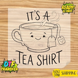 May include: Black and white graphic of a smiling teacup with steam, tea bag, and the words "IT'S A TEA SHIRT". The design includes a heart on the tea bag and is labeled "READY! TO PRESS" and "DTF TRANSFER".
