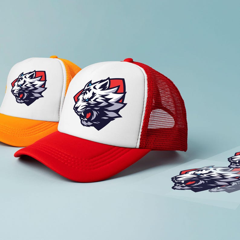 May include: Two trucker hats featuring a tiger logo. One hat is red and white, the other is yellow and white. The tiger logo is white, black, and red, set against a red background. The hats have a mesh back.