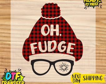 May include: A DTF transfer design featuring a red and black plaid hat with the words "OH. FUDGE" in white. Below the hat are black glasses with a sunburst design on one lens. The design is ready to press.