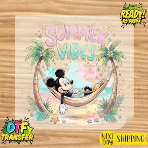 May include: A DTF transfer sheet featuring a graphic of Mickey Mouse relaxing in a hammock between two palm trees. The text reads SUMMER VIBES in light purple and teal. The design includes watercolor splashes, starfish, and seashells.