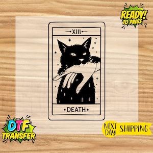 May include: Black and white tarot card design featuring a black cat holding a hand, with the word "DEATH" at the bottom. The card is labeled "-XIII-" at the top. The image also includes "READY! TO PRESS" and "DTF TRANSFER" text.