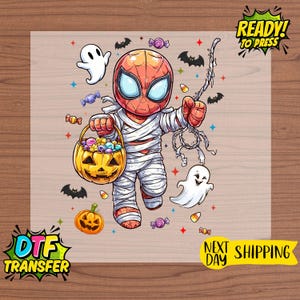 May include: A DTF transfer featuring a cartoon Spider-Man dressed as a mummy, holding a pumpkin basket filled with candy. The design includes ghosts, bats, and the text "READY! TO PRESS".