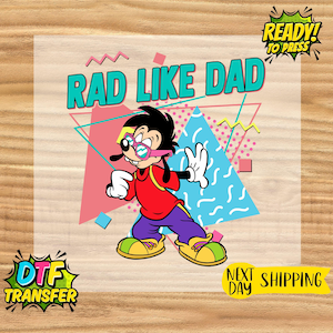 May include: A colorful DTF transfer featuring a cartoon character wearing glasses and a red shirt, with the text "RAD LIKE DAD". The design includes geometric shapes in pink, blue, and yellow, with the words "READY! TO PRESS" in a speech bubble.