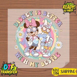 May include: A colorful DTF transfer featuring Minnie Mouse and Daisy Duck with the text "Disney is Better With My Bestie." The design includes a rainbow background, daisies, and stars. The words "Ready to Press" and "Next Day Shipping" are also visible.
