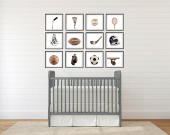 May include: A nursery room with a white crib and a white wall with 12 framed pictures of sports equipment, including a basketball, baseball, football, hockey stick, lacrosse stick, boxing gloves, skateboard, tennis racket, soccer ball, and a pair of sneakers.