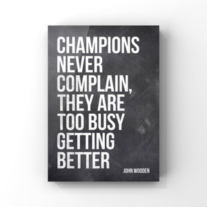 May include: Black and white motivational quote on a chalkboard background. The quote reads "Champions never complain, they are too busy getting better." The quote is attributed to John Wooden.