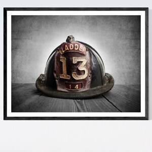 May include: A vintage black firefighter helmet with a red leather patch that says "Ladder 13" in gold lettering.