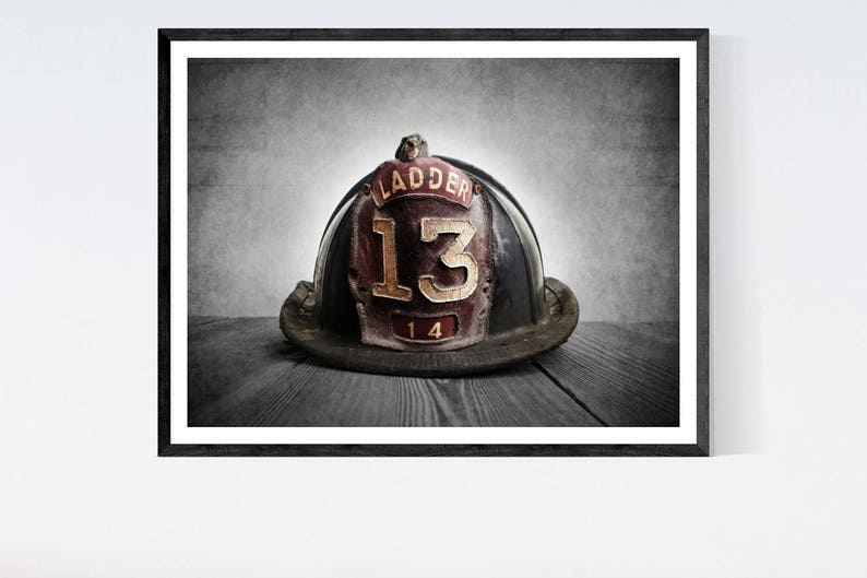 May include: A vintage black firefighter helmet with a red leather patch that says "Ladder 13" in gold lettering.