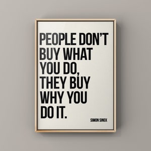 May include: A framed print with a white background and black text that reads "PEOPLE DON'T BUY WHAT YOU DO, THEY BUY WHY YOU DO IT." The text is attributed to Simon Sinek.