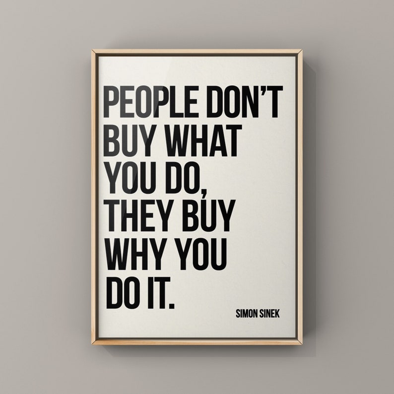 May include: A framed print with a white background and black text that reads "PEOPLE DON'T BUY WHAT YOU DO, THEY BUY WHY YOU DO IT." The text is attributed to Simon Sinek.