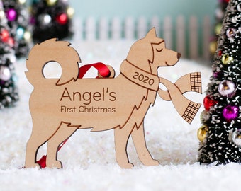 May include: A wooden dog ornament with a red scarf and the text "Angel's First Christmas" and "2020".