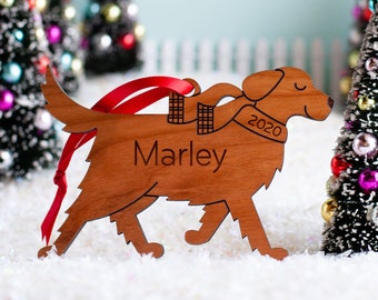 May include: Wooden Christmas ornament shaped like a dog wearing a scarf and a sweater. The ornament is personalized with the name "Marley" and the year "2020".
