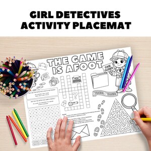 May include: A white activity placemat with the text "GIRL DETECTIVES ACTIVITY PLACEMAT" and "THE GAME IS AFOOT". The placemat features detective-themed illustrations, a crossword puzzle, and a maze. A pot of coloured pencils is visible.