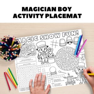 May include: A white activity placemat with the text "MAGICIAN BOY ACTIVITY PLACEMAT" and "MAGIC SHOW FUN!". The placemat features illustrations of a magician, a rabbit in a hat, a maze, and a crossword puzzle. Colored pencils and crayons are visible.