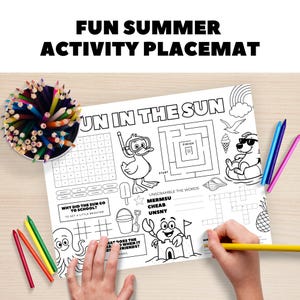 May include: A white activity placemat with the text "FUN SUMMER ACTIVITY PLACEMAT" and "UN IN THE SUN". The placemat features various summer-themed activities, including a maze, word scramble, and crossword puzzle. Colored pencils and crayons are visible.