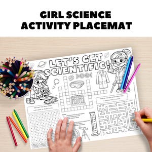 May include: A white activity placemat with the text "GIRL SCIENCE ACTIVITY PLACEMAT" and "LET'S GET SCIENTIFIC!". The placemat features science-themed illustrations, a crossword puzzle, and a maze. Colored pencils are visible.
