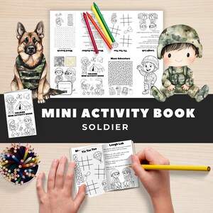 May include: A "Mini Activity Book" with the word "SOLDIER" is displayed, along with a German Shepherd dog wearing a camouflage vest. The book features word searches, mazes, and tic-tac-toe. Colored pencils and a watercolor illustration of a soldier are also present.