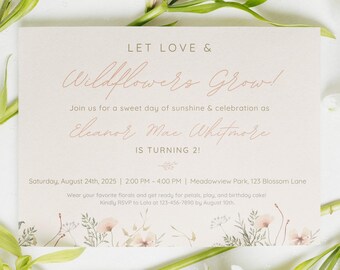 May include: A light beige invitation with the text "LET LOVE & Wildflowers Grow!" in a delicate script. The invitation is for Eleanor Mac Whitmore's 2nd birthday, with event details and floral accents. The invitation is surrounded by white flowers.