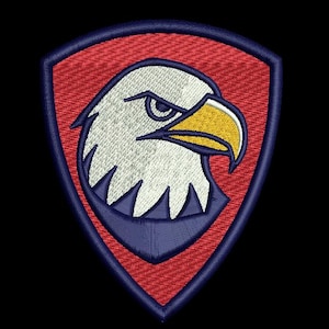 May include: Embroidered patch featuring a stylized eagle head within a shield shape. The eagle has white feathers, a yellow beak, and a stern expression. The shield has a red background with a blue border, suitable for jackets, bags, or other apparel.