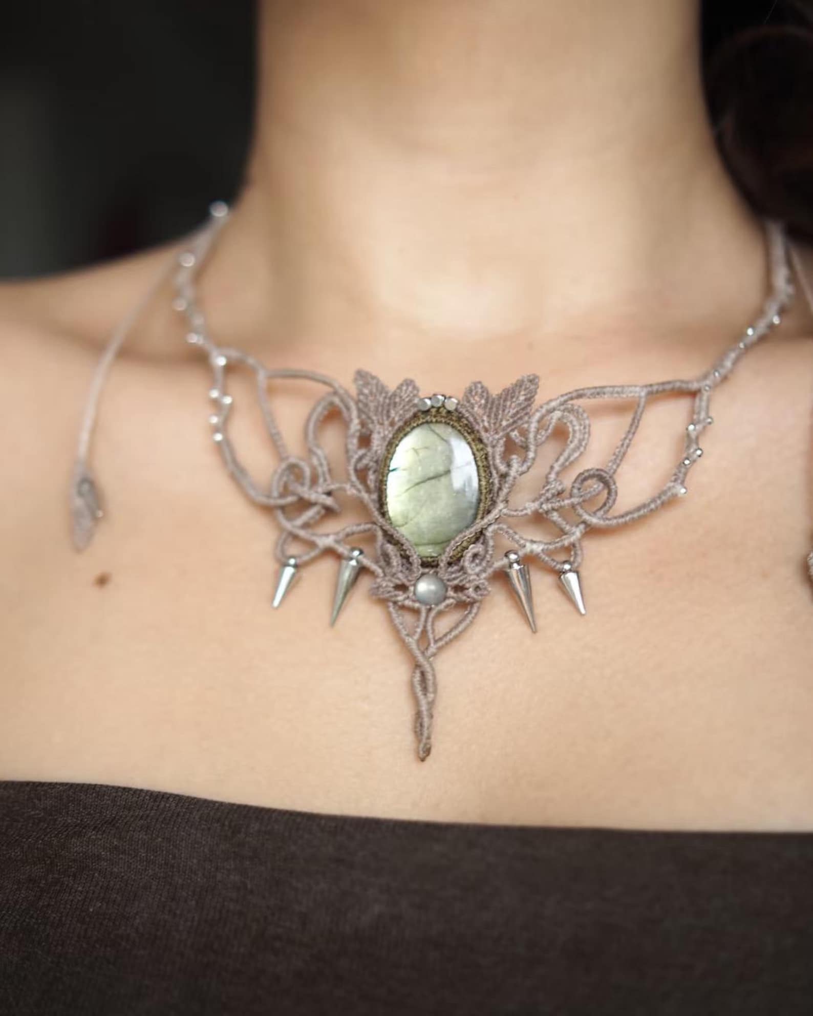 Labradorite macrame choker with silver beads and spikes worn at the collarbone.