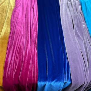 May include: Five different colors of velvet fabric, including gold, pink, blue, purple, and turquoise.