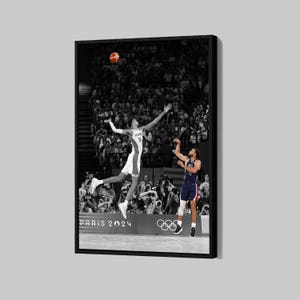 May include: Black and white framed print of a basketball game. A player in a white uniform with the number 3 jumps to shoot the ball, while another player in a blue uniform prepares to shoot. The text "PARIS 2024" is visible.