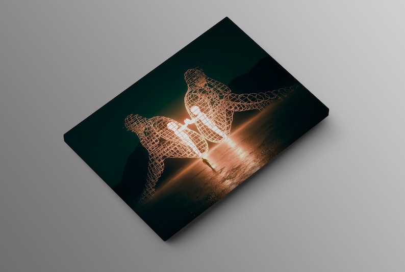 May include: A canvas print featuring a surreal artwork. Two wireframe human figures are depicted, seemingly embracing, with a bright light emanating from their center. The background is a dark teal, with a warm, golden glow.