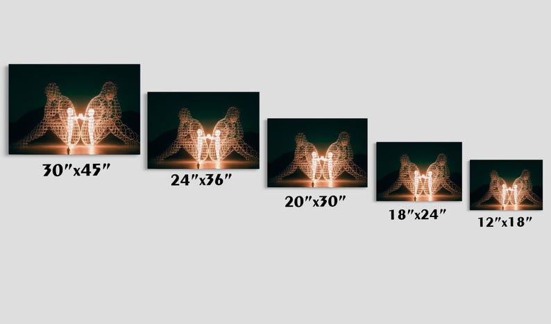 May include: Canvas art prints featuring a glowing sculpture of two figures embracing a central light source. Available in various sizes, including 30"x45", 24"x36", 20"x30", 18"x24", and 12"x18". The artwork has a dark green background.