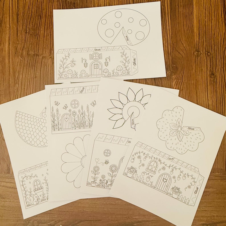 Puede incluir: Un conjunto de recortes de papel blanco con varios dise&ntilde;os, incluyendo una casa, una mariquita, un girasol y otros elementos florales y arquitect&oacute;nicos. Los recortes est&aacute;n destinados a la artesan&iacute;a e incluyen la palabra "Glue".