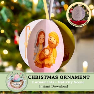 Op de afbeelding: Een kerstversiering met een illustratie van de kerststal. De bolvormige versiering heeft een roze achtergrond en een tekening van Maria, Jozef en het kindje Jezus. Inclusief kleurplaten. De tekst luidt "CHRISTMAS ORNAMENT".