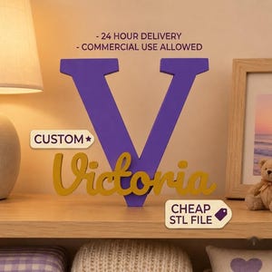 May include: A large purple letter V with the name Victoria in gold script lettering layered over the front. The image includes text stating 24 HOUR DELIVERY, COMMERCIAL USE ALLOWED, CUSTOM, and CHEAP STL FILE, indicating a digital design file.