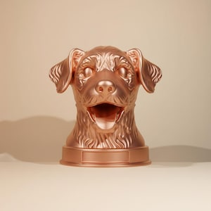 May include: A rose gold dog head sculpture with an open mouth and detailed fur texture. The sculpture has a rectangular base, and the dog's features are clearly defined. The background is a neutral beige.