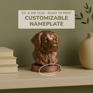 May include: A bronze-colored dog bust with a customizable nameplate. The sculpture has detailed fur and facial features. The text on the image reads: "STL & 3MF FILES - READY TO PRINT CUSTOMIZABLE NAMEPLATE."