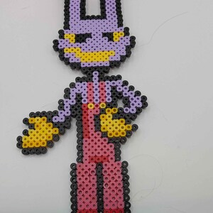 May include: A pixel art figure made from colorful plastic beads. The figure has a purple head with yellow accents, a pink body, and black and yellow arms. The figure is standing with its arms out.