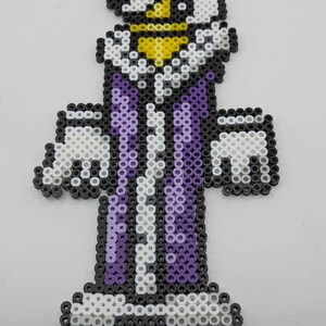 May include: A pixel art figure of a character in a purple and white outfit with a yellow crown. The figure is made of small, colorful beads, with black beads outlining the design. The figure has a white beard and mustache.
