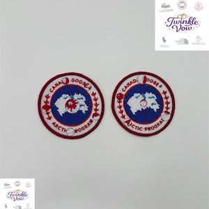 May include: Two circular Canada Goose embroidered patches. Each patch features a white map of the Arctic, surrounded by a blue ring and a red border. The text "CANADA GOOSE ARCTIC PROGRAM" is embroidered around the edge.