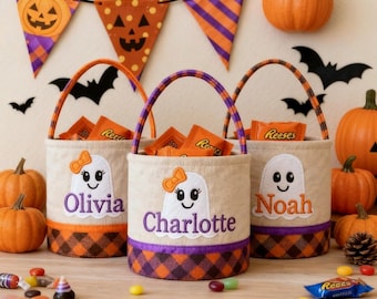 May include: Three Halloween treat bags filled with sweets, each featuring a ghost design and a name: Olivia, Charlotte, and Noah. The bags have orange handles and a plaid trim. Pumpkins and Halloween decorations complete the festive scene.