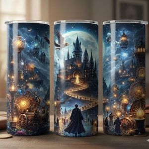 May include: Three stainless steel tumblers with a fantasy castle design. The artwork features a large castle, a path of people, and a full moon in a night sky. The tumblers have a detailed, colorful illustration.