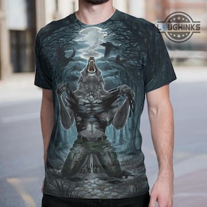 May include: A dark blue t-shirt featuring a werewolf transforming under a full moon in a forest setting. The design includes ravens and a path leading to the moon. The shirt has the text "LAUGHINKS" on the upper right.