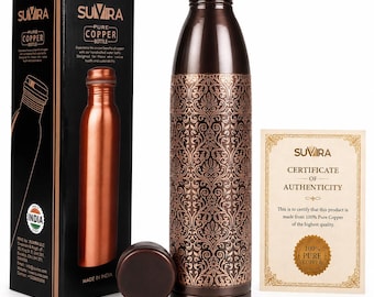 May include: A dark brown copper water bottle with an intricate floral pattern, a matching screw-on cap, and a black product box labeled Suvira Pure Copper Bottle, accompanied by a gold-bordered Certificate of Authenticity document.