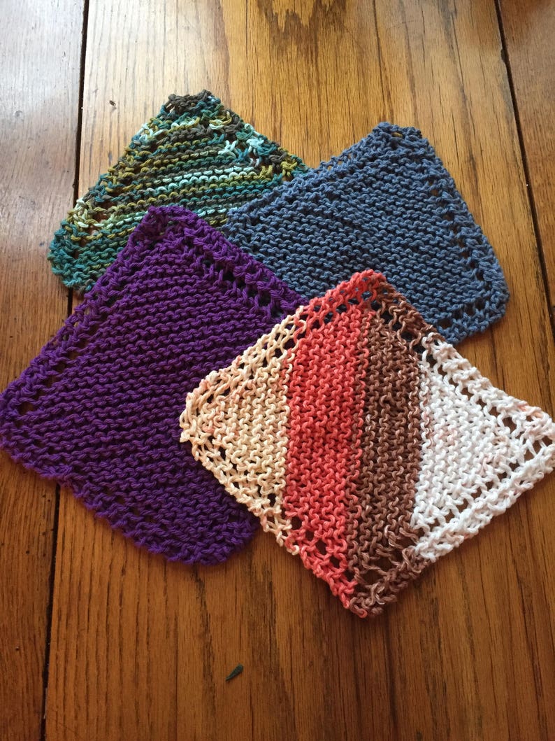 May include: Four knitted dishcloths in different colors and patterns. The dishcloths are purple, blue, green, and a multi-colored stripe pattern.