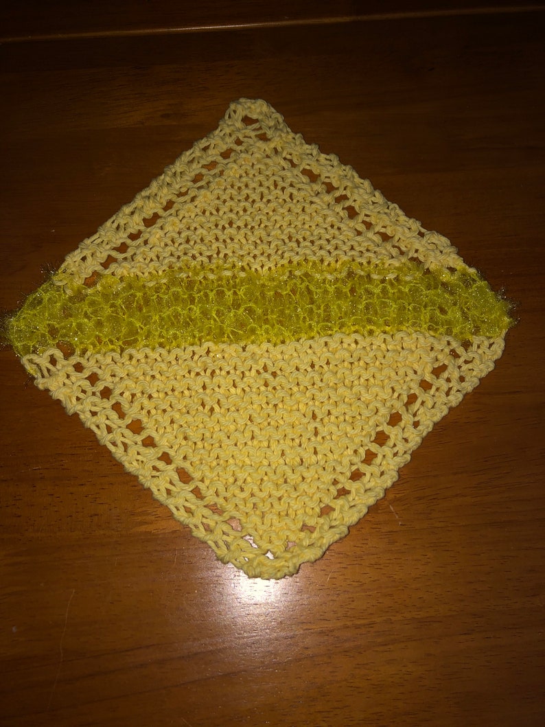 May include: A yellow knitted dishcloth with a sparkly yellow stripe in the center.