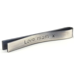 Back of tie clip shown with personal message elegantly hand stamped on the back. Lettering is dark and deep and shows up well against the antiqued silver surface.