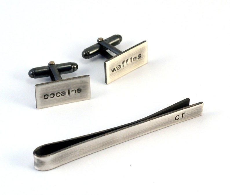 Tie clip is shown with matching silver cuff links which can be purchased separately in my shop. Both cuff link fronts and tie clip are personalised with text which is deep and dark and stands out well.