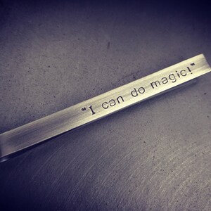 Elegant, darkened silver tie clip displays the words "I can do magic!" on the front. This tie clip can be personalised with any phrase or text on the front, or the back.