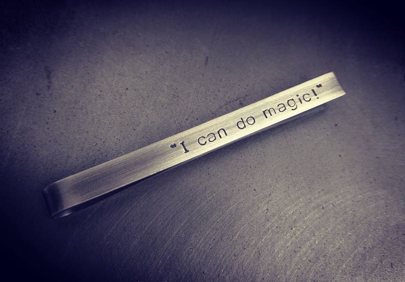 Elegant, darkened silver tie clip displays the words "I can do magic!" on the front. This tie clip can be personalised with any phrase or text on the front, or the back.