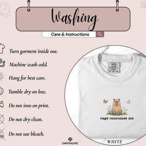 May include: White crewneck sweatshirt with a capybara graphic, two butterflies, and the text "rage consumes me." Washing instructions are displayed above the sweatshirt.